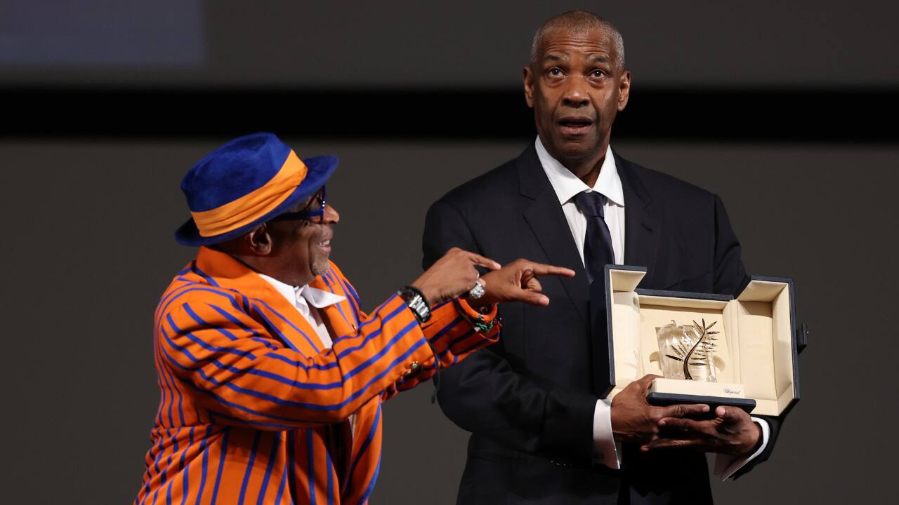 U.S. actor Denzel Washington receives the Honorary Palme d'Or from U.S. director and executive producer Spike Lee ahead of the screening of the film "Highest 2 Lowest" at the 78th edition of the Cannes Film Festival in Cannes, southern France. (Photo: AP) 