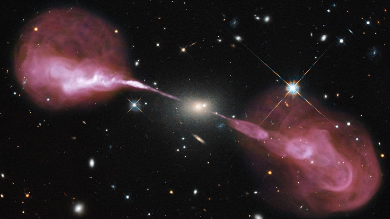 Black Hole Jets in Hercules A: Spectacular jets powered by the gravitational energy of a supermassive black hole in the core of the elliptical galaxy Hercules A as imaged by Hubble Space Telescope's Wide Field Camera 3 and the Karl G. Jansky Very Large Array (VLA) radio telescope in New Mexico. (Image: Canva)