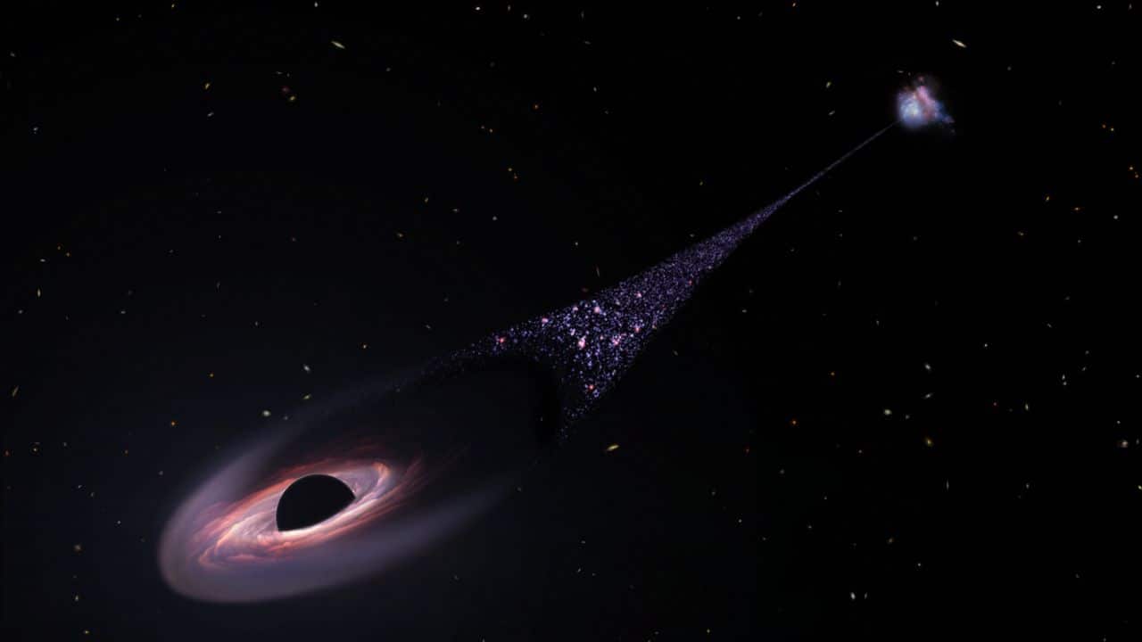 Artist’s Concept of a Runaway Black Hole: This is an artist's concept of a runaway supermassive black hole that was ejected from its host galaxy as a result of a tussle between it and two other black holes. As the black hole plows through intergalactic space it compresses tenuous gas in front of it. This precipitates the birth of hot blue stars. This illustration is based on Hubble Space Telescope observations of a 200,000-light-year-long trail of stars behind an escaping black hole. (Image: NASA)