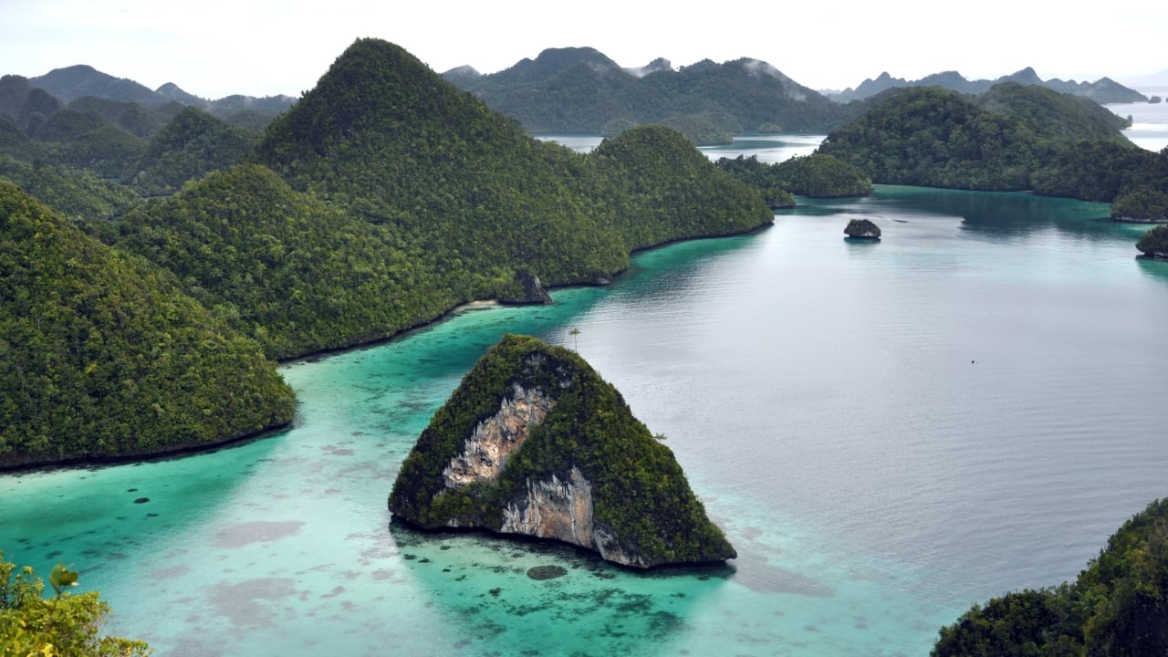 5. Raja Ampat, West Papua Often dubbed the crown jewel of diving, Raja Ampat’s technicolor reefs, secret lagoons, and soaring limestone cliffs make it the most biodiverse marine paradise on Earth — bar none. (Image: Canva)