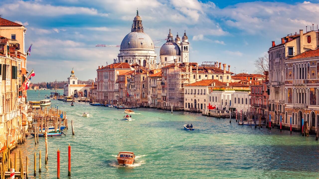 2. Venice, Italy Venice’s labyrinth of canals, historic architecture, and timeless charm is like nowhere else on Earth. Yet rising sea levels and frequent floods threaten to engulf this floating city. Explore its romantic streets and grand piazzas before the tides claim them. (Image: Canva)