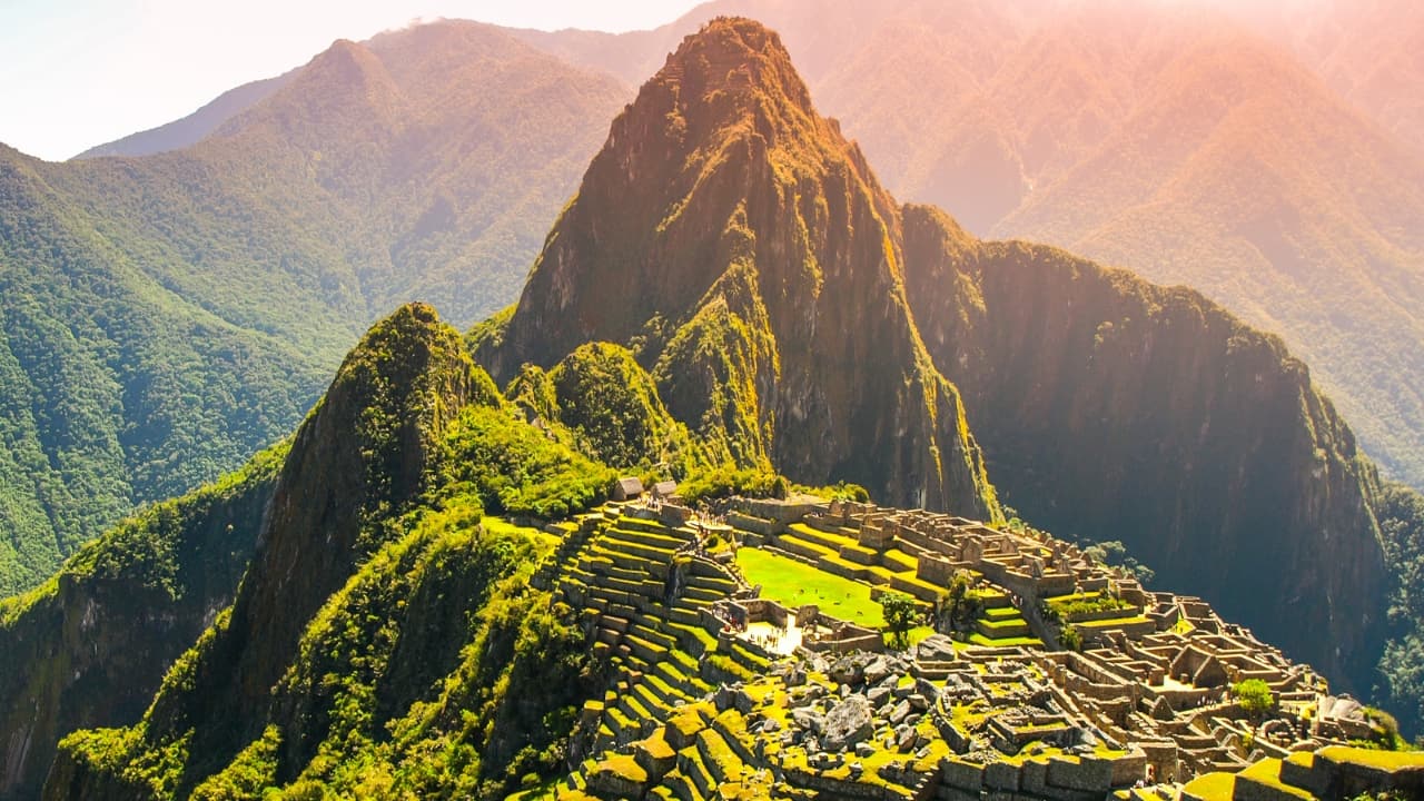 3. Machu Picchu, Peru Perched high in the Andes, Machu Picchu stands as a breathtaking testament to Incan mastery. But the combined pressures of tourism and natural erosion are slowly wearing down this ancient site. Trek the legendary Inca Trail to experience its magic while it lasts. (Image: Canva)