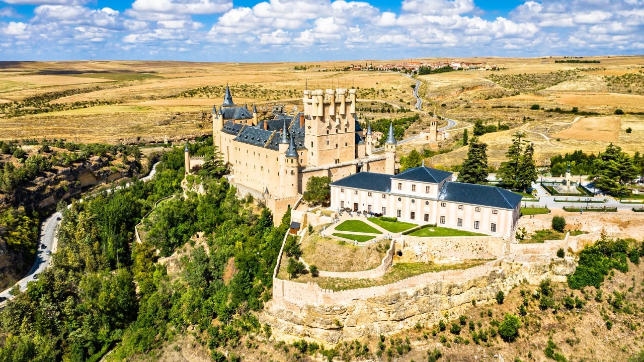 5. Alcázar of Segovia, Spain Shaped like a ship sailing out of a rocky cliff, the Alcázar of Segovia was once a royal palace and military stronghold. Its slender towers and richly decorated halls have inspired everything from Disney tales to Spanish legends — and for good reason. (Image: Canva)