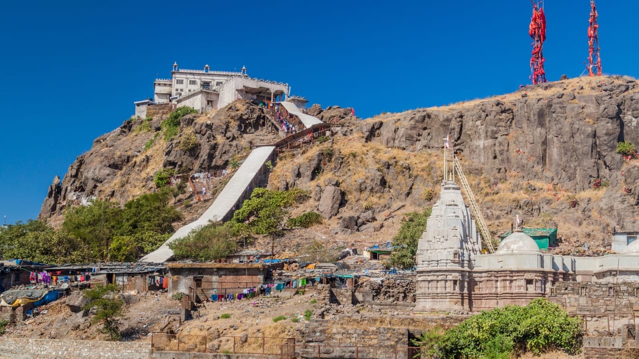 4. Pavagadh – Climb, Breathe, Reflect More than a pilgrimage site, Pavagadh is an experience in contrasts. It’s where myth meets mist, and history clings to the hillside. As you ascend via cable car or foot, the landscape unfolds — thick woods, rocky cliffs, and ancient ruins. It’s part of the UNESCO-listed Champaner-Pavagadh Archaeological Park, but it’s also a hill station in disguise. (Image: Canva)