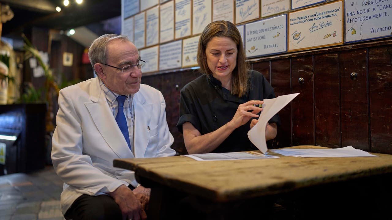 Irene Guinales, right, and Pedro Guinales del Valle, owners and managers of Casa Pedro restaurant, review documents regarding the restaurant’s opening date in Madrid, Spain, on May 16, 2025. (AP Photo/Manu Fernandez)