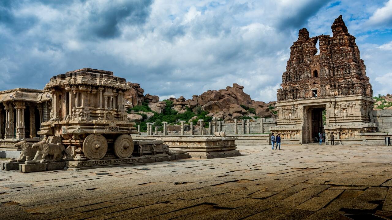 3. Hampi, Karnataka – Stone Meets Storm Rain polishes the ruins of Hampi into cinematic brilliance. Watch moss crawl over ancient temples, rivers swell near boulder-strewn hills, and time itself slow down in this open-air museum. (Image: Unsplash)