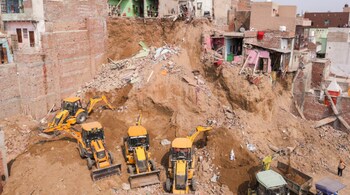 Rescue operation underway after a multi-storey building and several other houses collapsed, in Mathura. (PTI Photo)