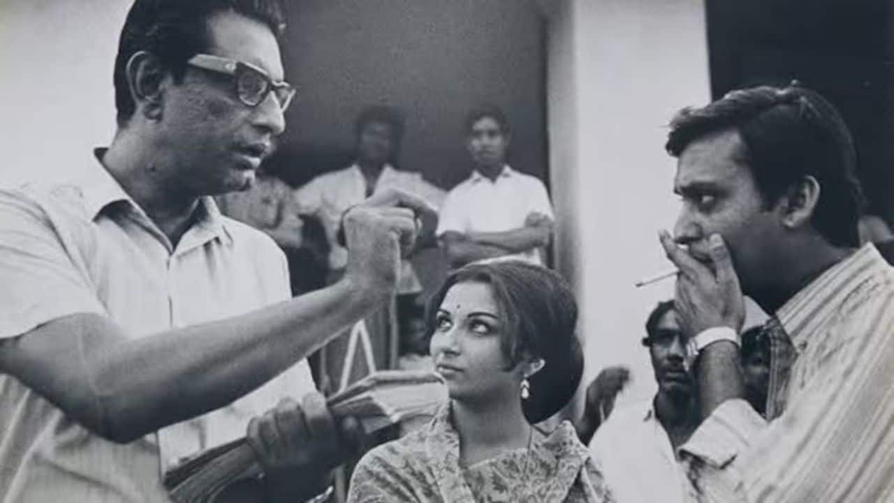 Satyajit Ray (left) directing Sharmila Tagore and Soumitra Chatterjee during Aranyer Din Ratri. (Photo via X)