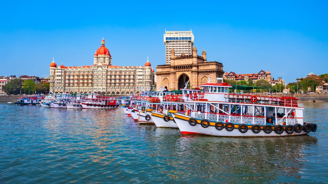 1. Mumbai – Maximum City, Minimum Time Needed A 24-hour trip to Mumbai is like plugging into a live wire. Catch golden hour at Marine Drive, grab midnight bites at Mohammed Ali Road, and dance the night away in Bandra or Lower Parel. With its cinematic chaos and coastal calm, Mumbai turns a micro-cation into a mega experience. (Image: Canva)