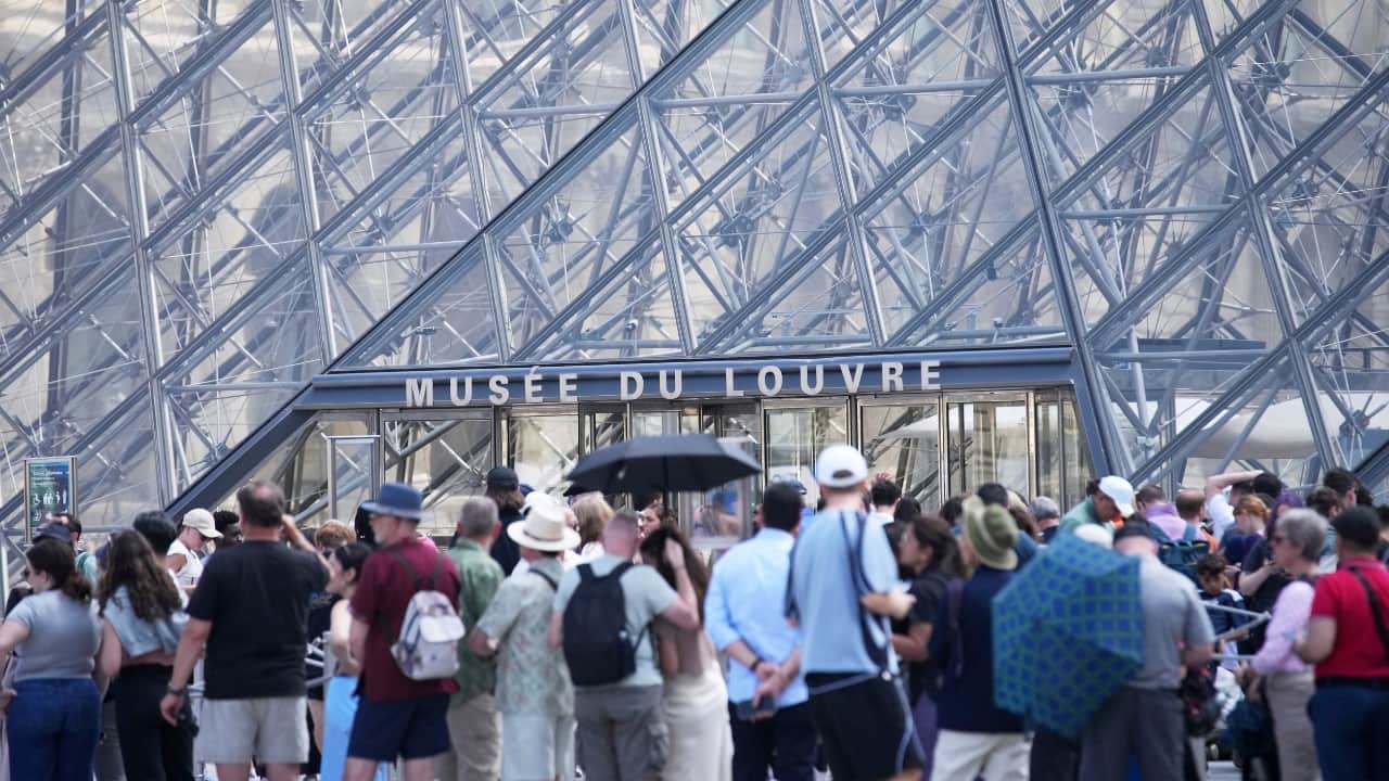 Tourists wait outside the Louvre museum which failed to open on time Monday, June 16, 2025 in Paris. (Image: AP)