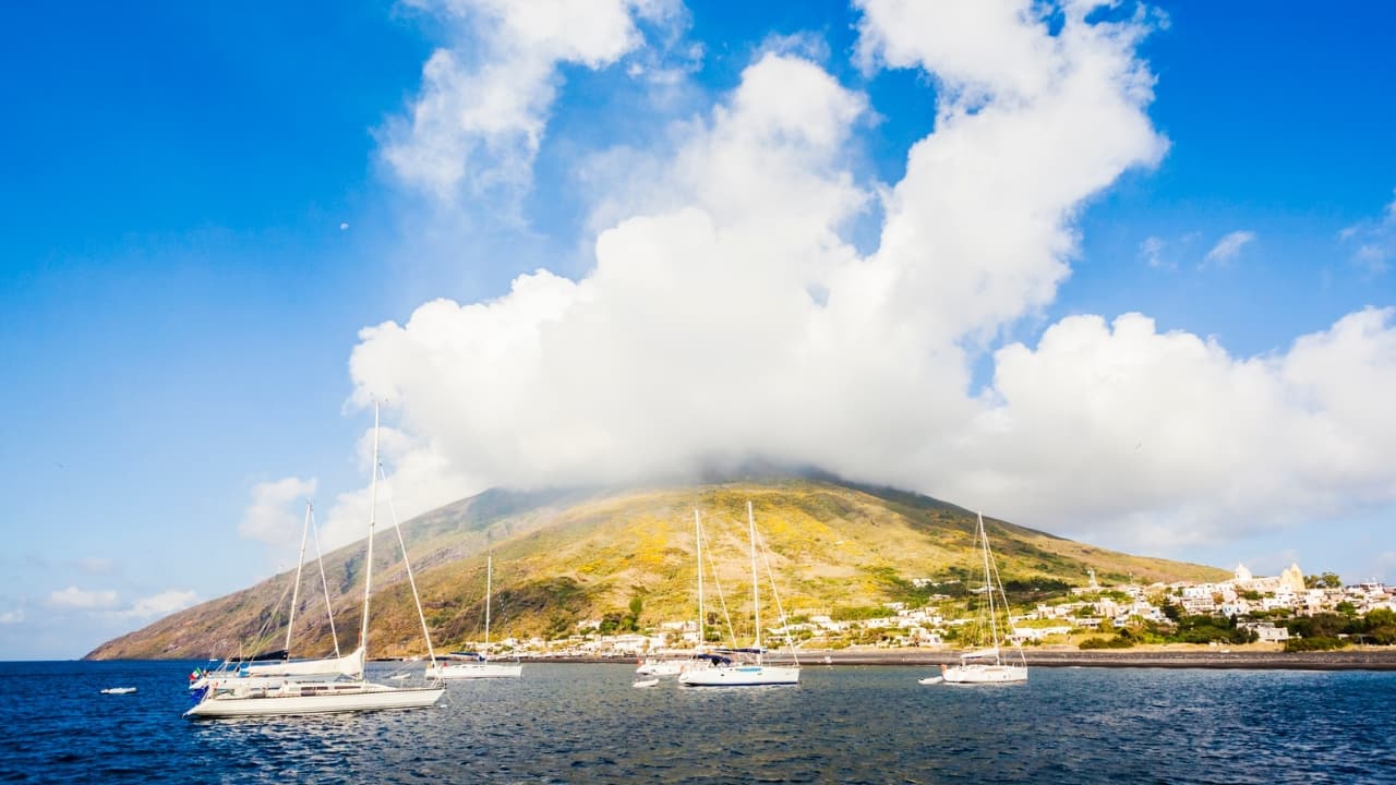 2. Stromboli, Italy: An island where the earth never sleeps Forget theme parks—Stromboli is real, raw, and constantly rumbling. Perched in the Tyrrhenian Sea, this live volcano has been erupting for over 2,000 years. Hike its black slopes by twilight, and you might witness lava arcing into the night sky like a fire-breathing exhale. It’s not just dramatic—it’s mythic. (Image: Canva)