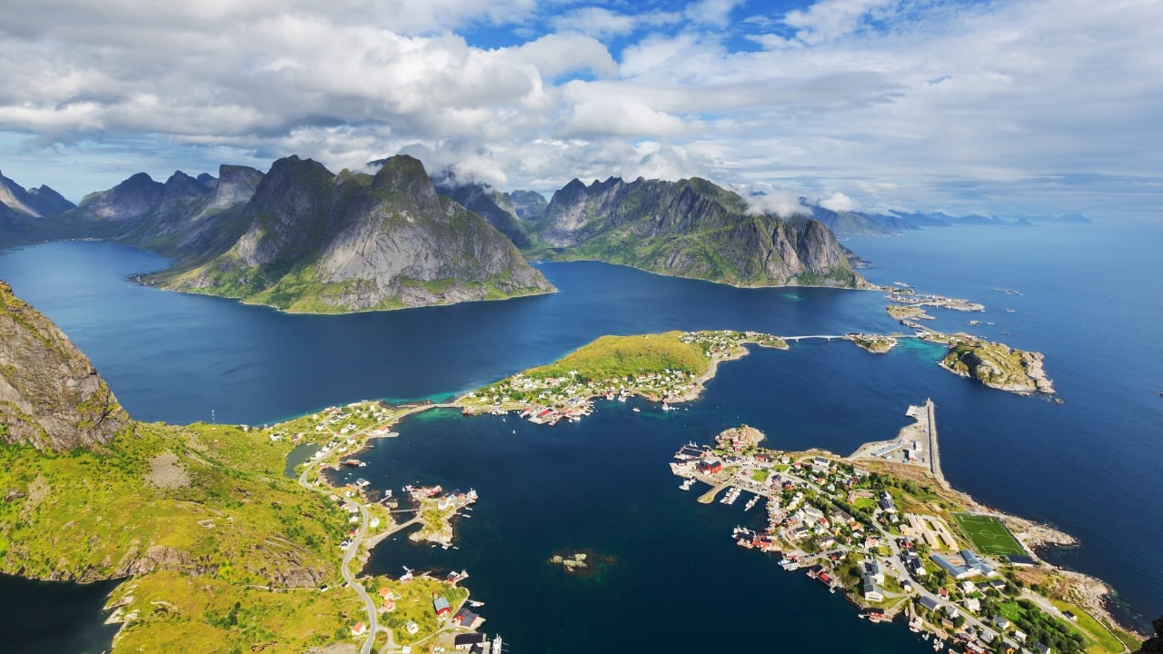 7. Lofoten Islands, Norway: Where the Arctic softens into poetry Up here, above the Arctic Circle, the sun never really sets in summer, and in winter, the sky is a theatre of green lights. Lofoten’s peaks shoot up from the sea like the bones of a sleeping giant, and fishing huts cling to the edge of everything. It’s not remote—it’s otherworldly. (Image: Canva)