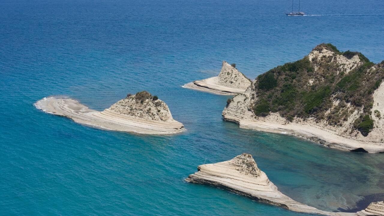 11. Ionian Islands, Greece: Where the water is bluer, and time less important Forget the crowded Cyclades. The Ionians offer a greener, gentler version of Greek island life. Here, beaches hide beneath cliffs, olive groves ripple in the breeze, and stone villages nap in the sun. Island-hop by sailboat, and let the world grow quiet again. (Image: Canva)