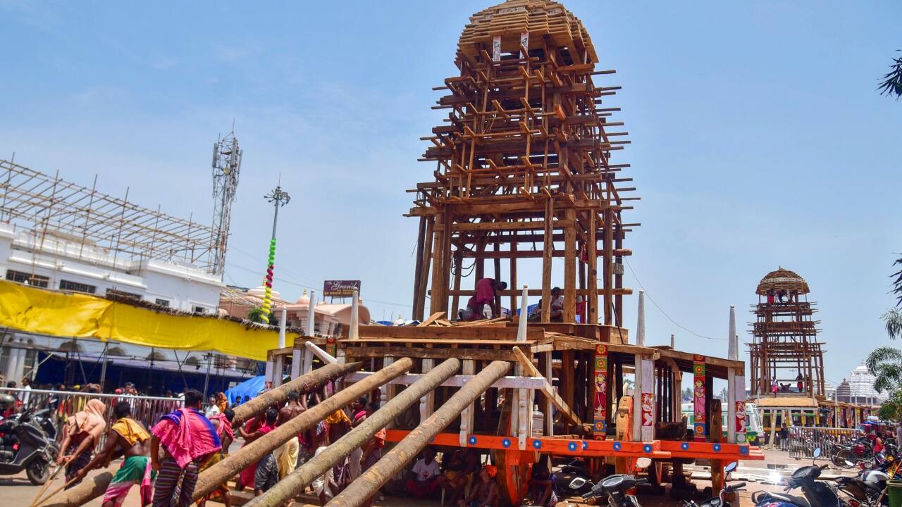 Skilled artisans craft the majestic chariots of Lord Jagannath, Balabhadra, and Devi Subhadra in preparation for the annual Rath Yatra festival on June 27 in Puri, Odisha. (Image: PTI)