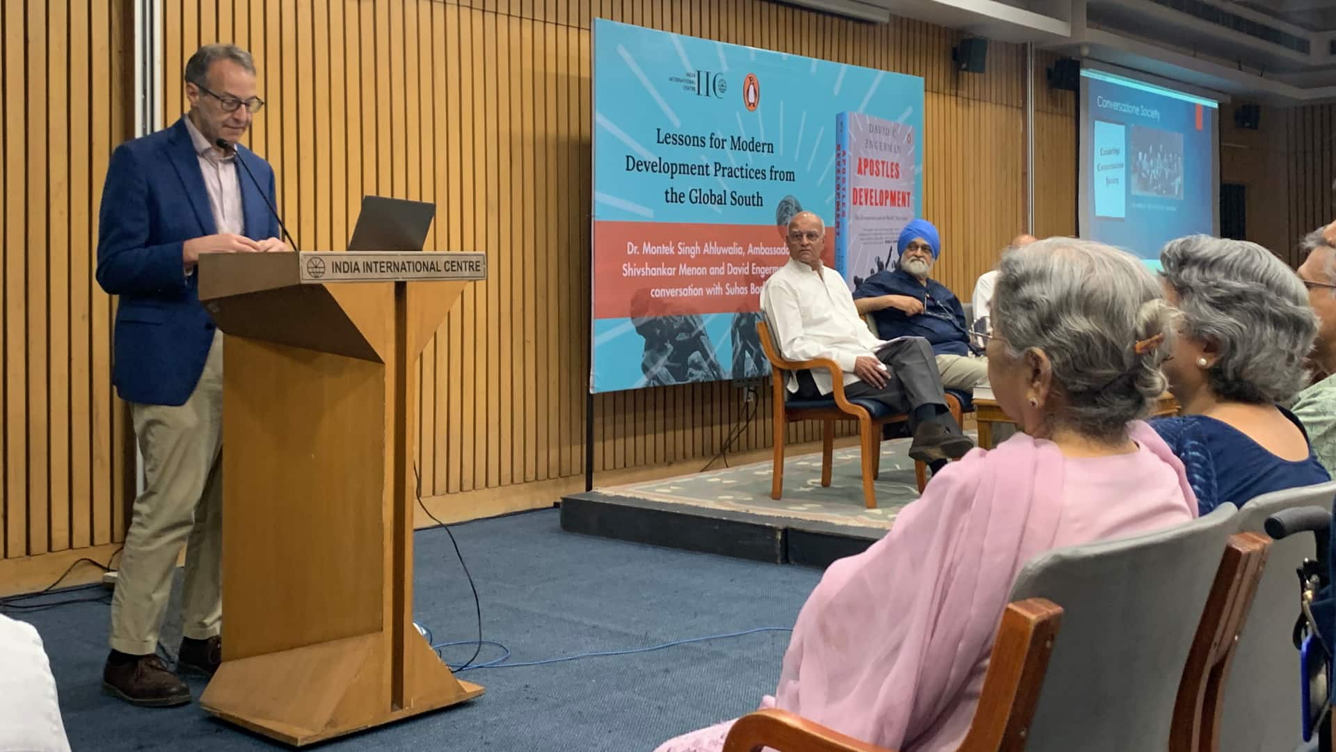 David C Engerman at the New Delhi launch of 'Apostles of Development' in June 2025. Also present, on the podium, are Shivshankar Menon and Montek Singh Ahluwalia, and in the audience, Gursharan Kaur, wife of the late Dr Manmohan Singh.