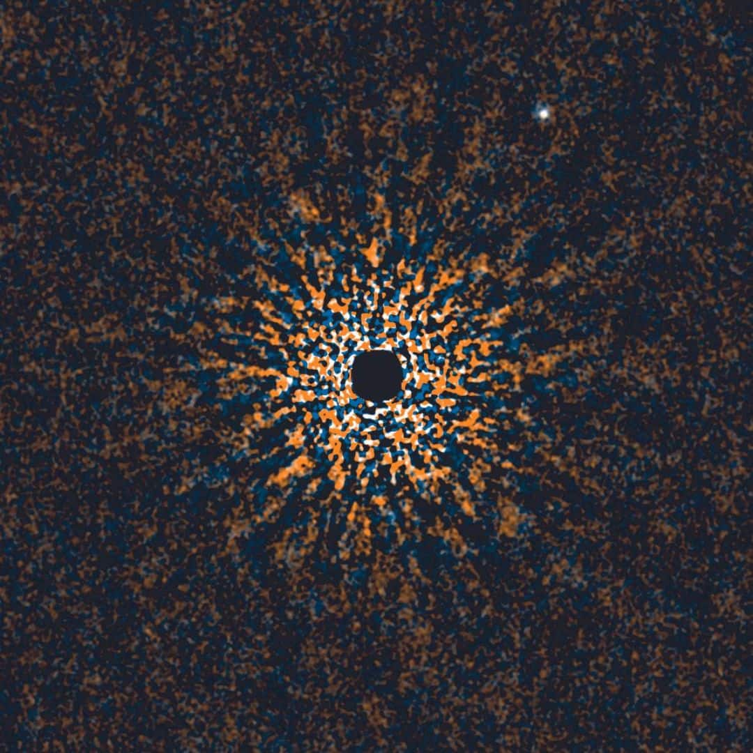 In the image, exoplanet GJ 504 b appears as a bright dot in the top right, positioned far from its star, GJ 504, shown as the large black dot at the centre. (Image: HiCIAO (High Contrast Instrument for the Subaru Next Generation Adaptive Optics/ AO188/NAOJ)