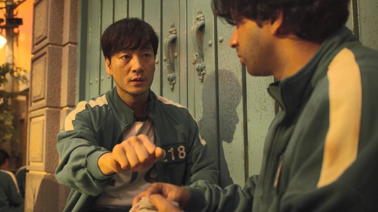 Squid Game Season 1 Episode 6 was emotionally devastating. During the marble game, each player was made to pair up with someone they trusted. Ali partnered with Sang-woo, but in a cold and calculated move, Sang-woo tricked Ali, leading to his death.
