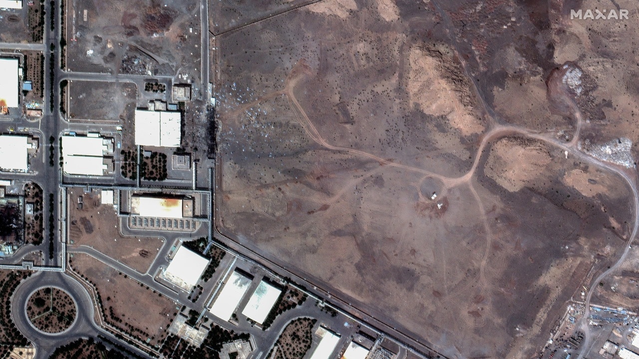 This handout satellite picture provided by Maxar Technologies shows airstrike craters over underground centrifuge halls filled and covered with dirt in Natanz nuclear enrichment facility in central Iran. 