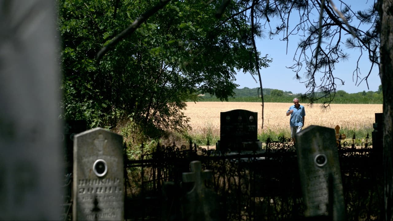 Mirko Bogicevic, 68, local resident and village's chronicler, passes by graveyards in Kisiljevo. (Image credit: AFP)