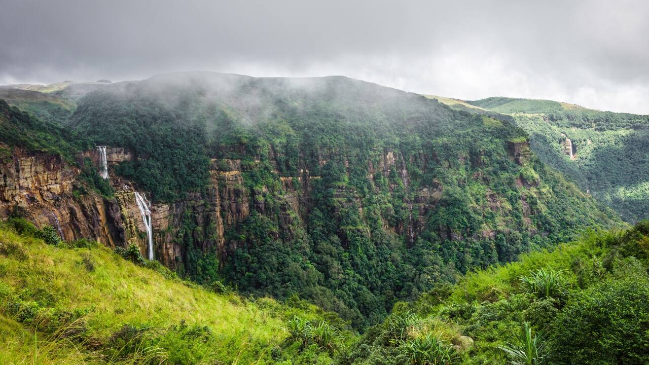 11. Cherrapunji Among the wettest places on Earth, Cherrapunji owns the monsoon like few others. Thundering waterfalls and cloud-heavy cliffs form a dramatic canvas that appeals to nature enthusiasts and photographers alike. (Image: Canva)
