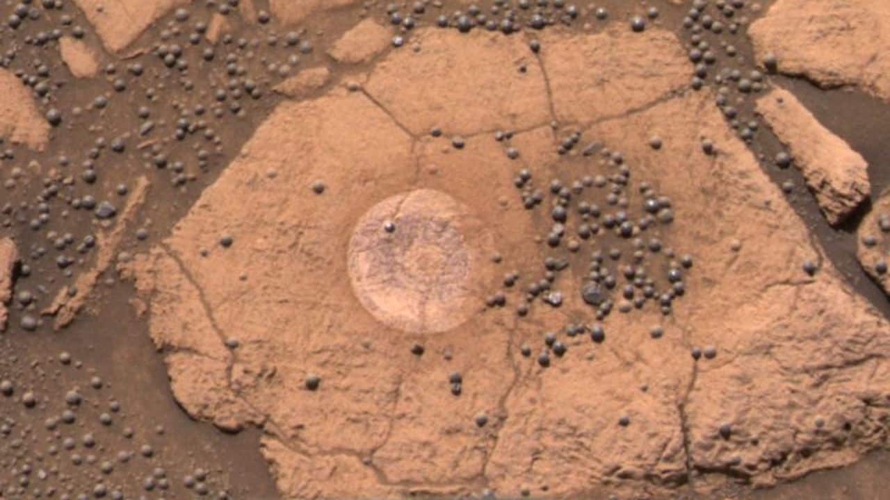 A Berry Bowl of Martian Spherules: Martian blueberries, tiny iron-rich spherules, were discovered by Opportunity in 2004. Evidence suggests they formed through slow mineral deposition from ancient water, offering clues about Mars’ watery past. (Image: NASA)