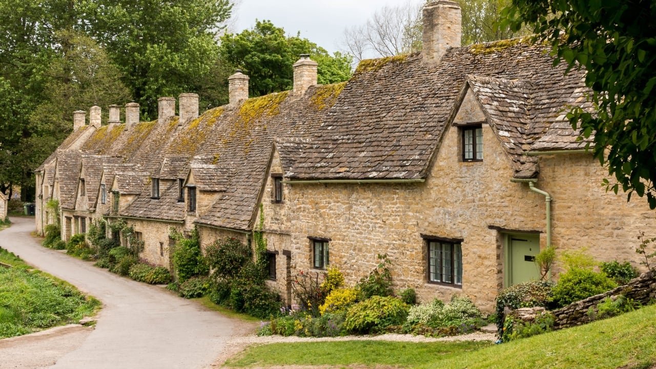 4. Bibury, England Set beside the Coln and stitched into the hills, Bibury whispers of England before speed. Honey-coloured cottages in tight rows, trout streams that glisten without reason, and hedgerows that seem older than maps. (Image: Canva)