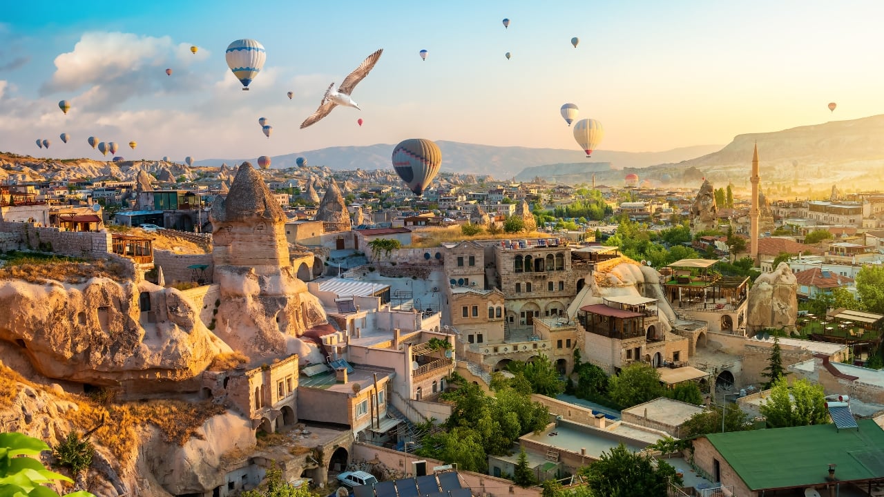 8. Goreme, Turkey Caves carved by wind and wonder—Goreme belongs to the Earth, not to man. Fairy chimneys pierce the sky, and hot-air balloons rise like thoughts at dawn. It is a village of both ground and sky. (Image: Canva)