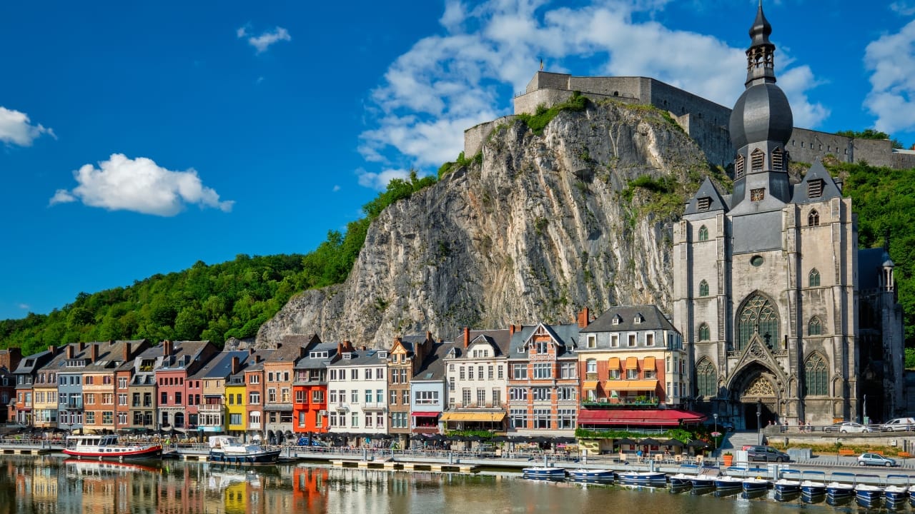 9. Dinant, Belgium Hemmed in by cliff and river, Dinant feels composed rather than built. Saxophones hang from bridges, limestone watches from above, and the Meuse flows through it like a quiet refrain. Gothic never looked so lyrical. (Image: Canva)