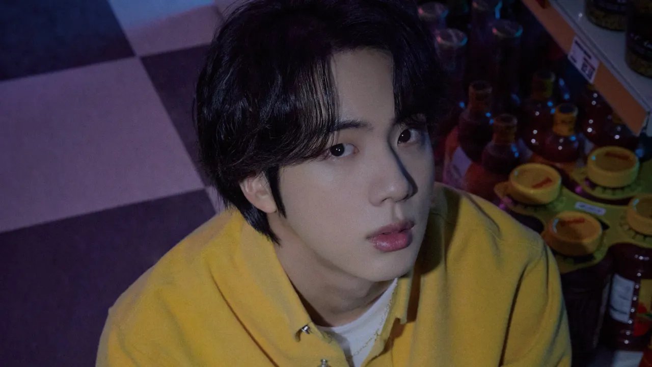 Jin sported a bright yellow overshirt, perched near the condiment aisle. He flaunts a gentle expression and classic look that blend with the vintage atmosphere of the general store. Jin sported a bright yellow overshirt, perched near the condiment aisle. He flaunts a gentle expression and classic look that blend with the vintage atmosphere of the general store.