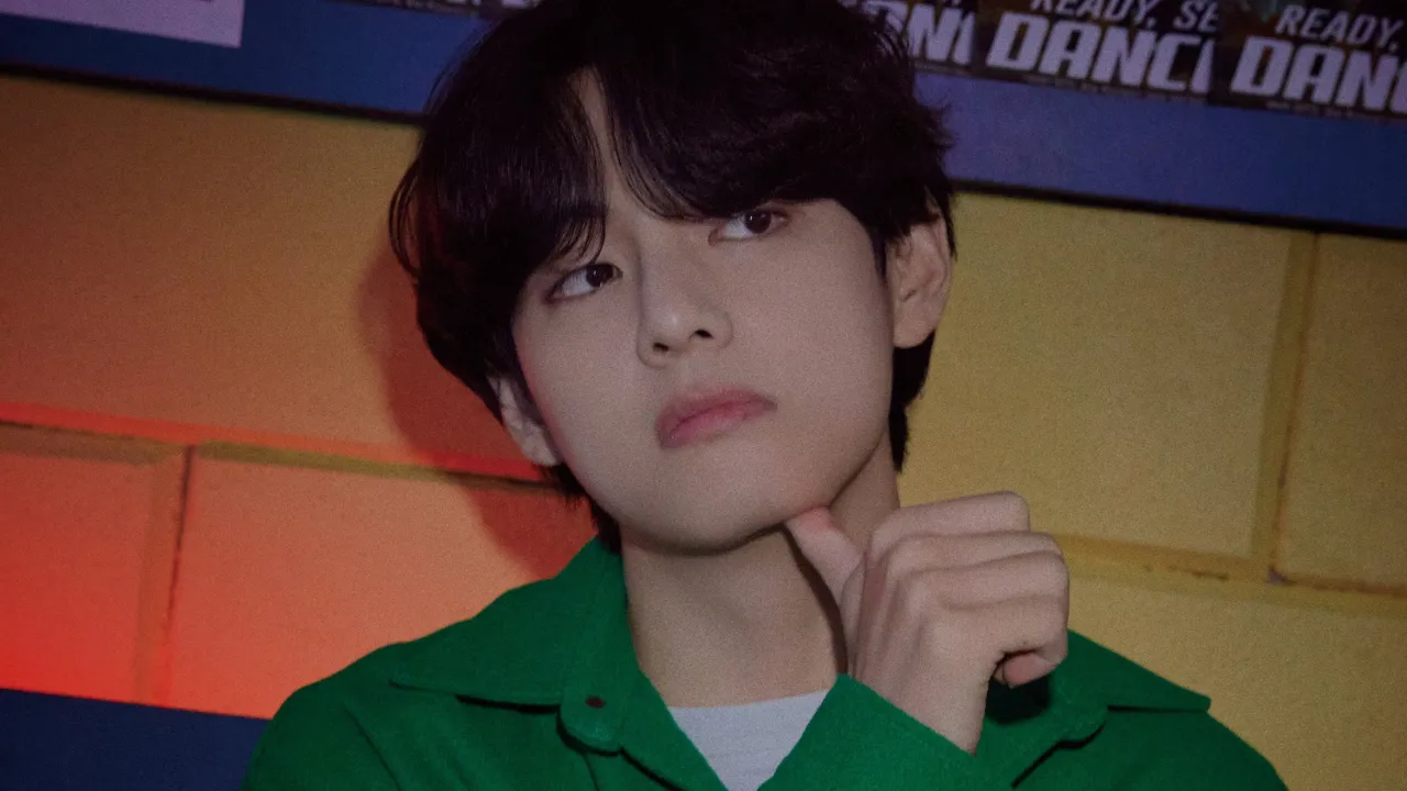 V (Taehyung), in a rich green jacket, stands against a yellow brick wall covered with BTS magazine posters. He poses with his hand resting thoughtfully under his chin, and his gaze and styled hair elevate the setting. V (Taehyung), in a rich green jacket, stands against a yellow brick wall covered with BTS magazine posters. He poses with his hand resting thoughtfully under his chin, and his gaze and styled hair elevate the setting.