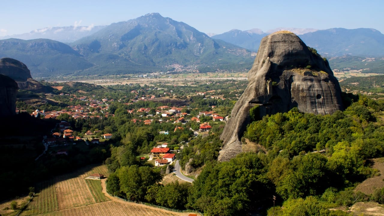 6. Kastraki – Beneath the Stones that Touch the Sky The spires of Meteora command attention, but the village of Kastraki, nestled at their feet, remains overlooked. Here, the stone houses sit shoulder to shoulder, their shutters creaking in the afternoon wind. As monasteries rise like fortresses above, life below moves with unthinking grace—slow meals, long shadows, children tracing paths older than memory. (Image: Canva)