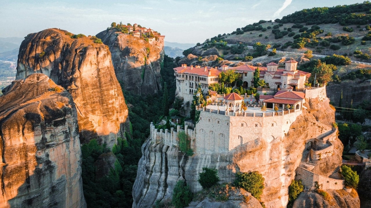 11. Meteora – Where Earth Reaches Up Though its stone spires and clifftop monasteries have earned global awe, Meteora still manages to feel unworldly. The crowds gather, yes—but move just a little beyond the outlooks and you’ll find paths through pine and silence. The very ground here feels lifted, as though Greece herself is reaching upward in prayer. Come at dusk, when the sky dims and the stone turns blue. You’ll see not a tourist site, but a cathedral without walls. (Image: Canva)