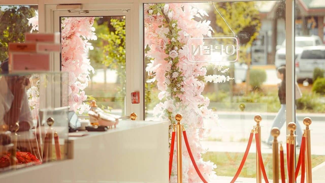 Guests step into Kap’s Café through a dreamy floral archway, setting the tone for the chic, Instagrammable experience inside. Every detail whispers elegance—even before the first sip. Guests step into Kap’s Café through a dreamy floral archway, setting the tone for the chic, Instagrammable experience inside. Every detail whispers elegance—even before the first sip.