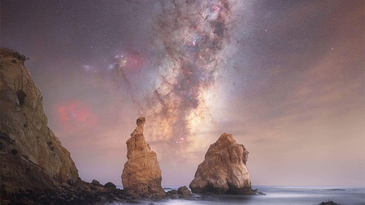 Milky Way Through Otago Spires: The Milky Way doesn't always align between these rocks—this rare view from New Zealand in June 2024 required perfect timing, showing the galaxy's bright core rising vertically after sunset. (Image: NASA)
