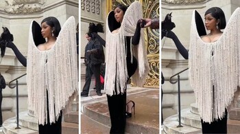 Cardi B's dramatic look got mixed reactions online, with many calling it a bold take on front-row fashion (Screengrabs: @PopBase/X)
