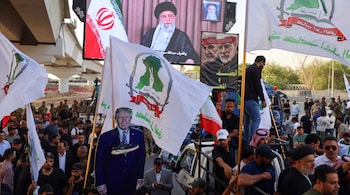 File Photo - Supporters of Iraqi pro-Iran groups hold a cutout of US President Donald Trump during a protest in support of Iran, in Baghdad near a bridge leading to the green zone, the ultra secured neighbourhood hosting the US embassy, on June 16, 2025.