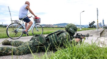 A soldier takes part in a training session during Taiwan's annual Han Kuang military exercise next to Patriot missile systems in Taipei on July 11, 2025. (Photo by I-Hwa Cheng / AFP)