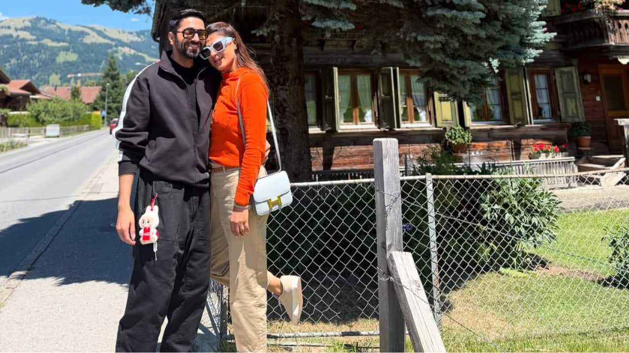 Love Under the Pines Standing close beneath a big pine tree, Ayushmann and Tahira share a soft, sweet moment together. Dressed in comfy outfits and warm smiles, they blend into the calm surroundings. Labubu doll peeking from Ayushmann’s pocket stole the spotlight