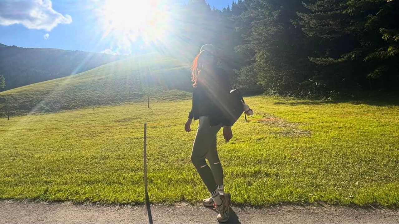 A Walk in the Sun Tahira is seen walking along a quiet path, with the sun shining brightly behind her. The golden light and open space reflect a peaceful moment. Surrounded by greenery, Tahira spent a beautiful family day outdoors.