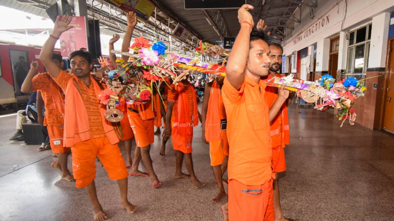 8. Patna, July 13: Devotees shout religious slogans as they get ready to leave for Baba Baidyanath Dham in Deoghar. (PTI Photo)