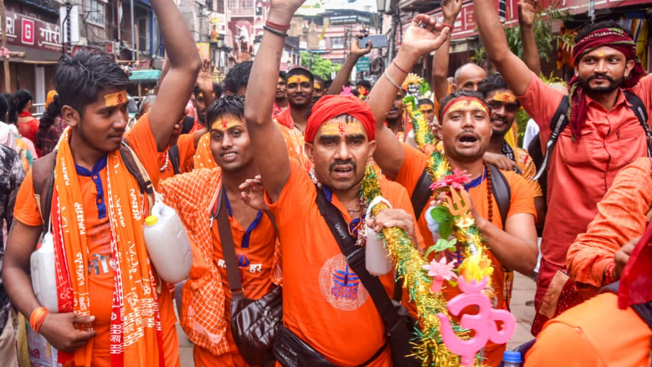 9. Varanasi, July 12: Kanwariyas visit Kashi Vishwanath Temple in Varanasi, raising chants with holy water in hand. (PTI Photo)