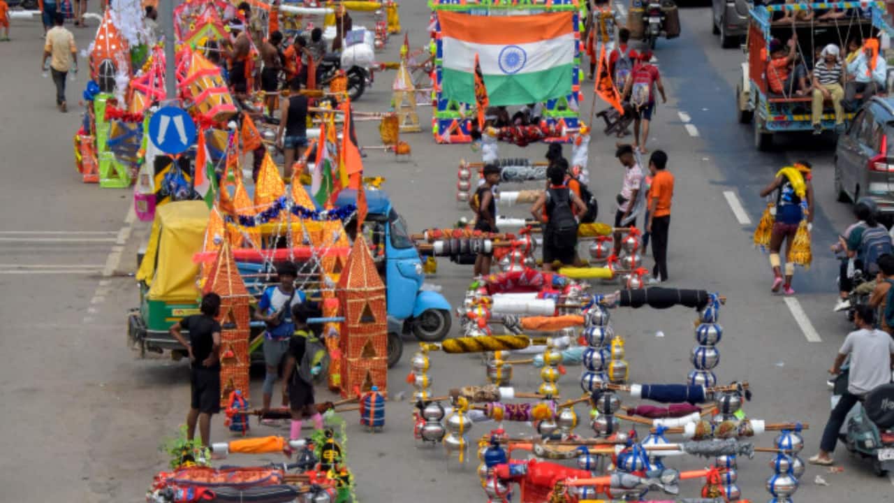 10. Moradabad, July 13: Kawads are kept on the roadside by devotees taking rest during their journey through Moradabad. (PTI Photo) 