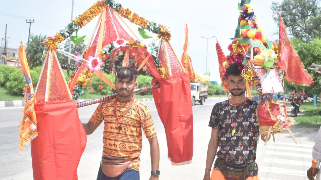 4. Meerut, July 13: Kanwariyas returning from Haridwar pass through Meerut carrying sacred water for Lord Shiva. (PTI Photo)
