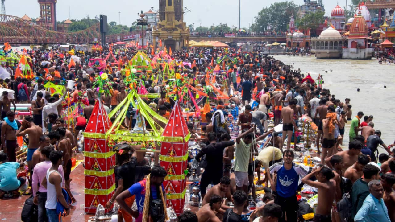 5. Haridwar, July 13: Devotees take a holy dip in the Ganga river at Haridwar during their spiritual Kanwar Yatra. (PTI Photo)