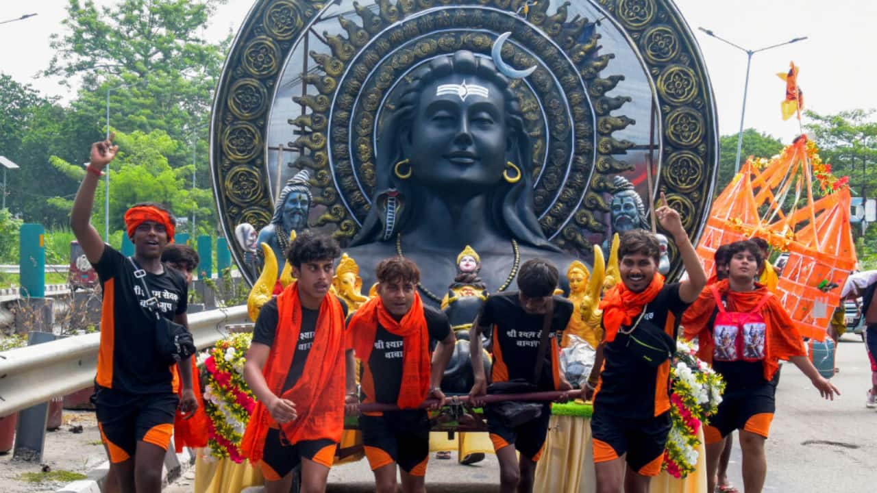 7. Haridwar, July 13: Kanwariyas pull an idol of Lord Shiva after collecting Ganga water in Haridwar. (PTI Photo)
