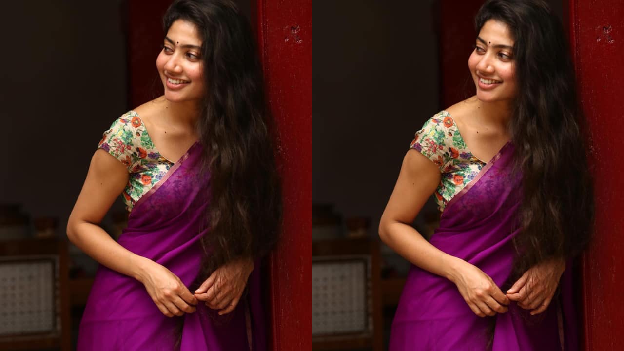 Sai Pallavi She is simplicity personified in a bold, striking purple-hued saree, paired with a soft and delicate multi-hued floral blouse. The colourful blouse adds life to the plain, solid saree. Sai’s natural hair and minimal makeup also do the trick, and make her look beautiful.