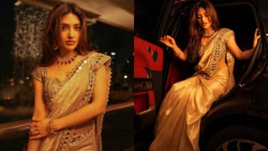 Sreeleela Sreeleela redefines opulence in a stunning saree worn with a blouse beautified with hand embroidery and hand-cut mirrors. It matches the border of her luxe gold saree, adorned with delicate sequins. She accessorised with a ruby necklace, adding a glamorous rich contrast.