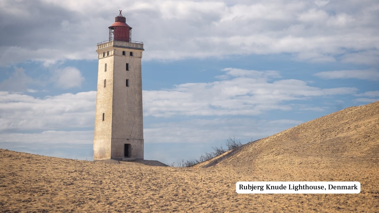 4. Rubjerg Knude Lighthouse, Denmark For over a century, this lighthouse stood its ground on Denmark’s North Sea coast, slowly losing its footing to advancing dunes. By 2019, it was moved inland to preserve its structure. Now standing amid shifting sands, it draws visitors intrigued by both its resilience and the stark, sculpted beauty of the surrounding cliffs. (Image: Canva)