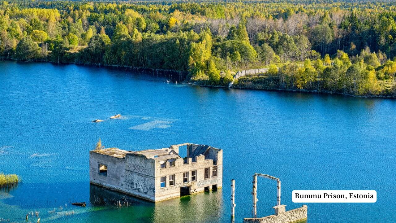 9. Rummu Prison, Estonia Abandoned in the early 1990s after the fall of the Soviet Union, Rummu’s prison and adjacent quarry slowly flooded. Today, the crystal-clear waters conceal submerged ruins, making it an otherworldly spot for swimming, paddleboarding, and diving—if you're brave enough to float above its dark history. (Image: Canva)