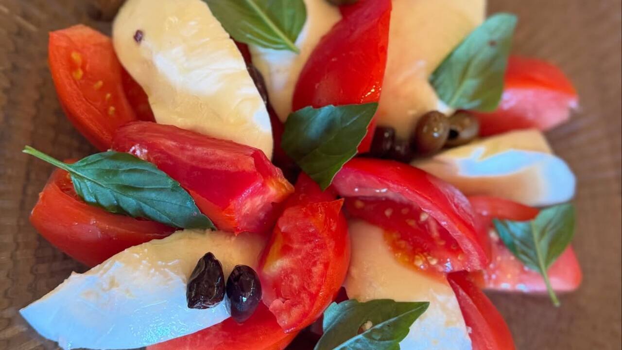 When in Italy, eat like the Italians - Tomatoes, mozzarella, basil, and capers—her plate is as picturesque as the scenery. 